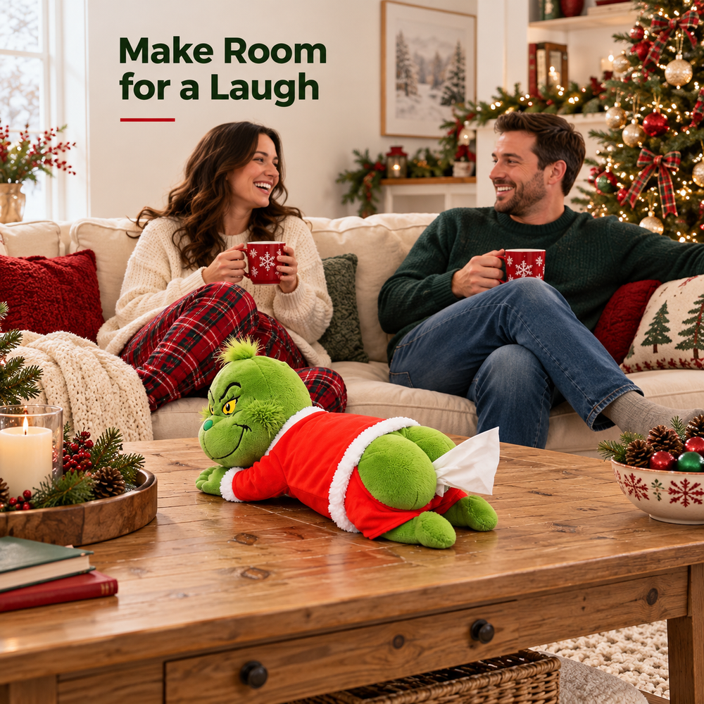 Couple laughing on a sofa while the funny Grinch plush tissue holder sits on a Christmas coffee table